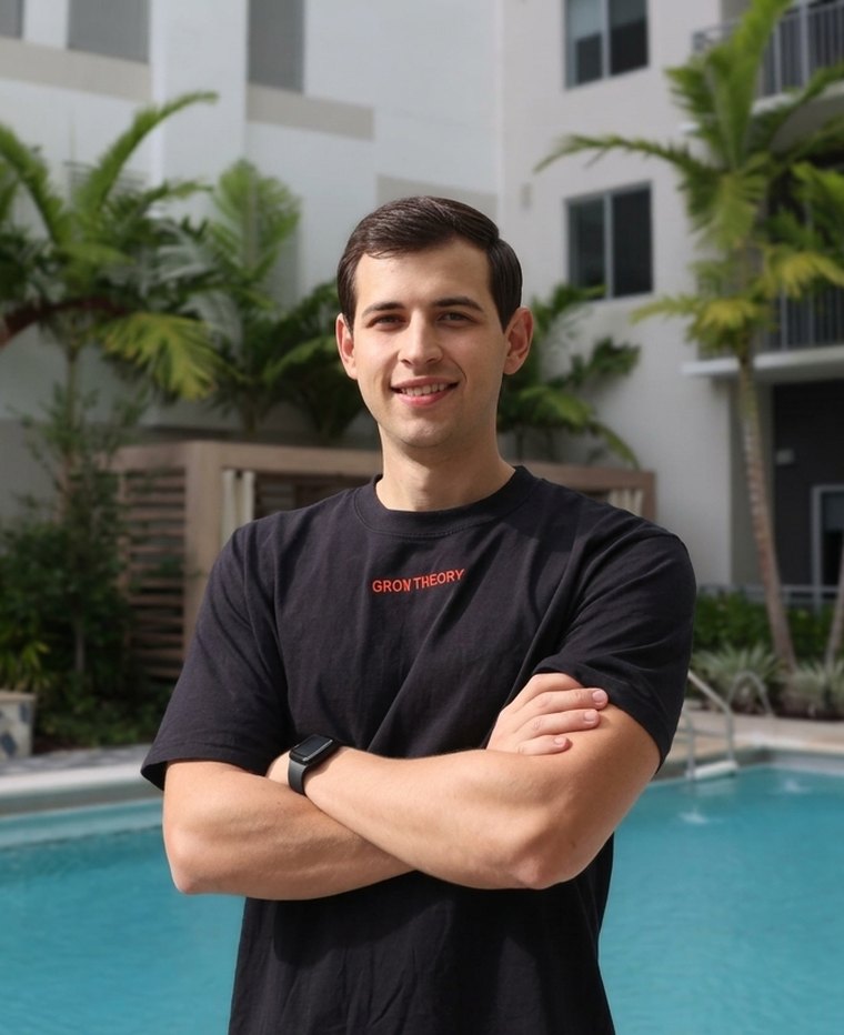 Steven Lenon, founder of Grow Theory, standing with arms crossed in a Grow Theory shirt